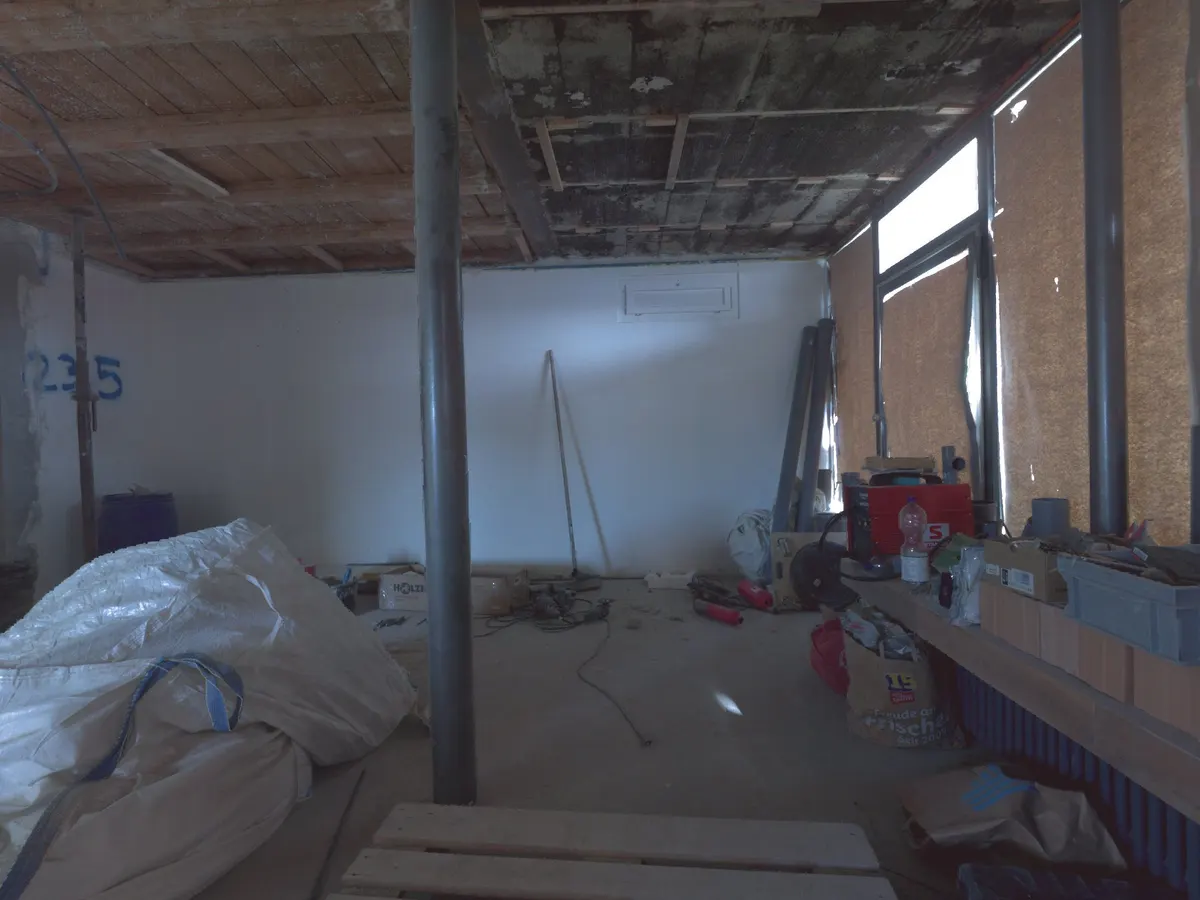 A construction room mid-works, cluttered with props and materials.